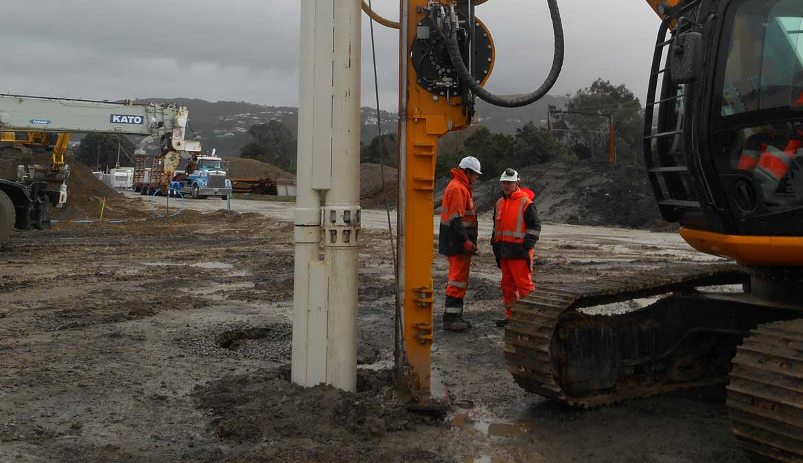 Stone column site — dry bottom-feed vibroflot rig and casing